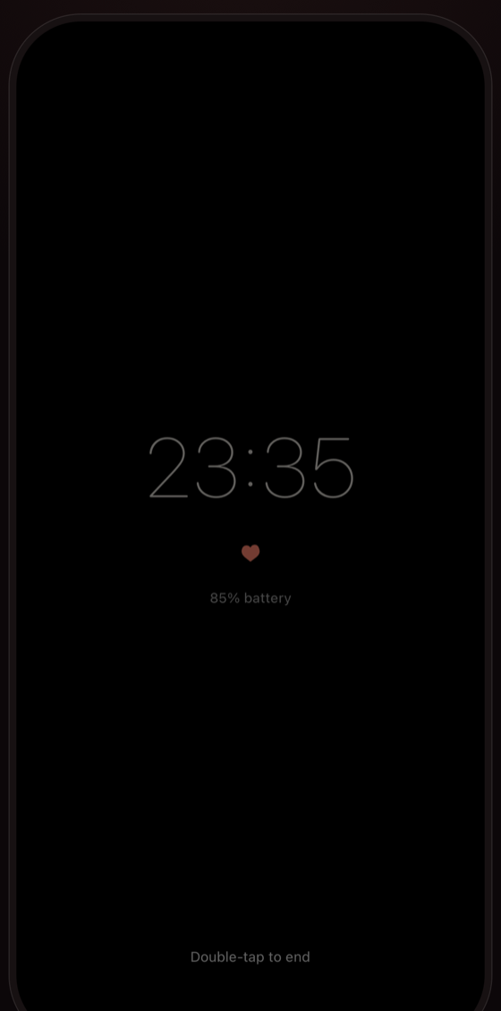 Lubb's session screen: true black with a dim clock, a small heart, and the battery level.